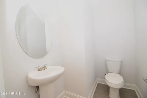 an empty room with a window and a chandelier fan