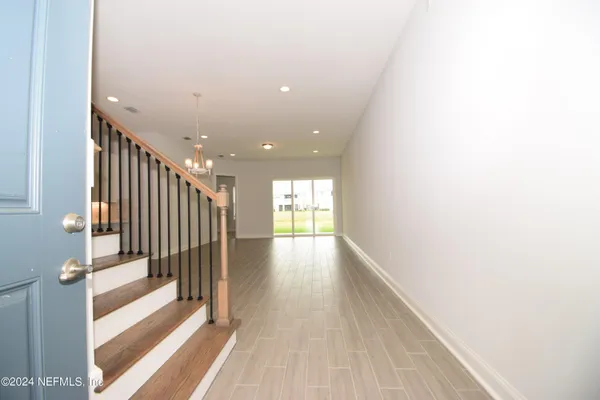 a view of gallery with wooden floor