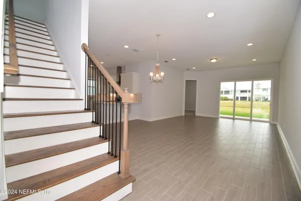 a view of an entryway with wooden floor