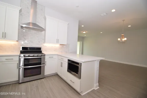 a kitchen with granite countertop a stove and a sink