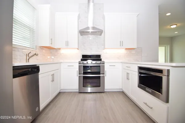 a kitchen with a stove oven and sink