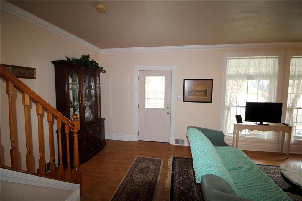 1334 Hamilton Road Pittsburgh, PA 15234 - Photo 3 of 22 Enter into the living room with crown moldings and laminate flooring.