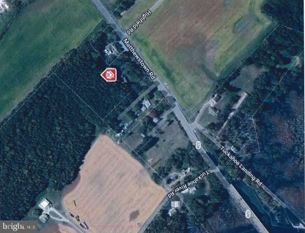 a view of hallway with stairs and wooden floor