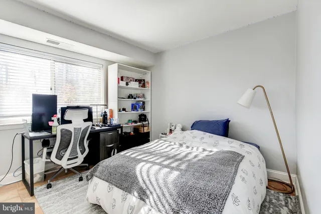 a bedroom with bed and window