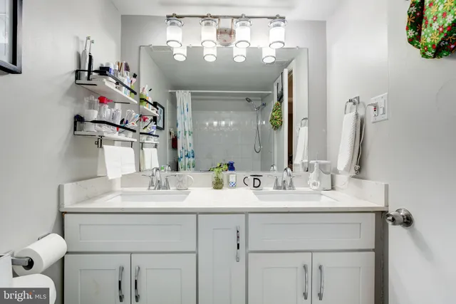 a bathroom with a sink vanity and a mirror