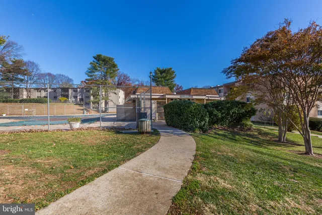 a view of a garden with a building in the background