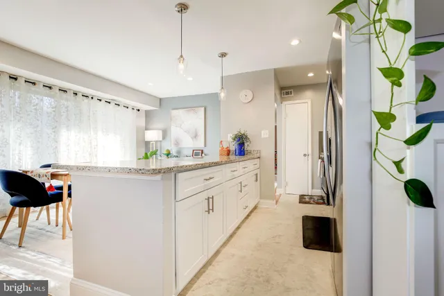 a kitchen with a refrigerator and a stove