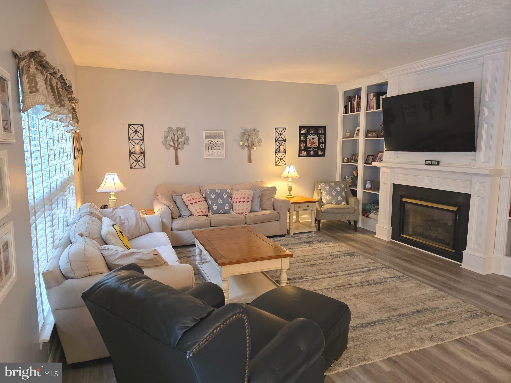 2441 Kemper Road Crofton, MD 21114 - Photo 26 of 63 a living room with furniture a flat screen tv and a fireplace