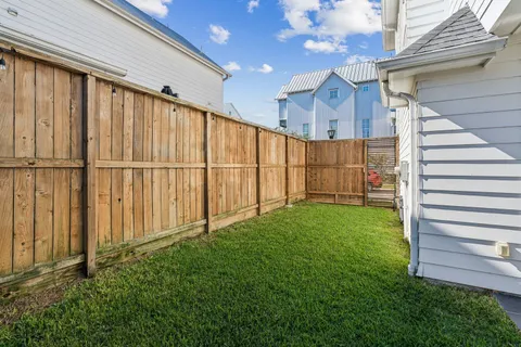 a view of a backyard with wooden fence