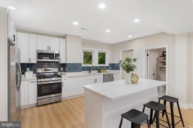 a kitchen with a stove a sink and a refrigerator