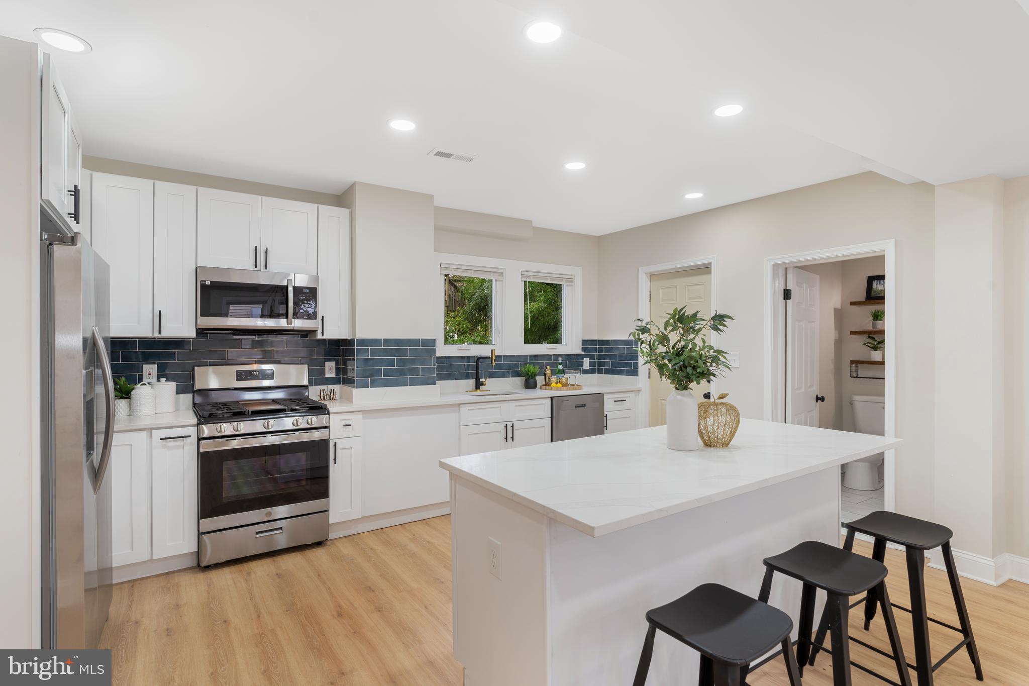 2905 Whitney Avenue Baltimore, MD 21215 - Photo 14 of 36 a kitchen with a stove a sink and a refrigerator