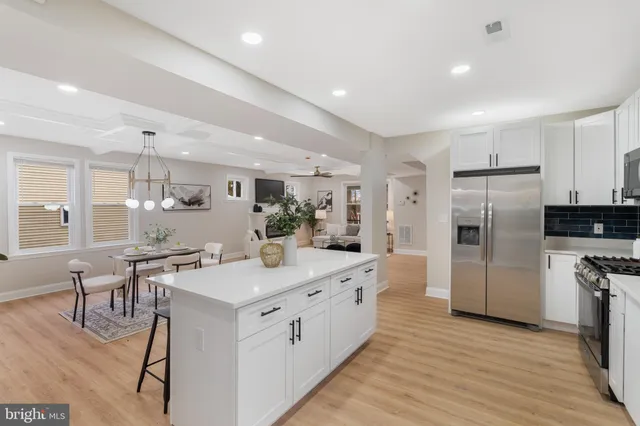 a kitchen with a sink stainless steel appliances and cabinets