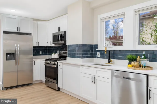 a kitchen with a sink a stove and refrigerator