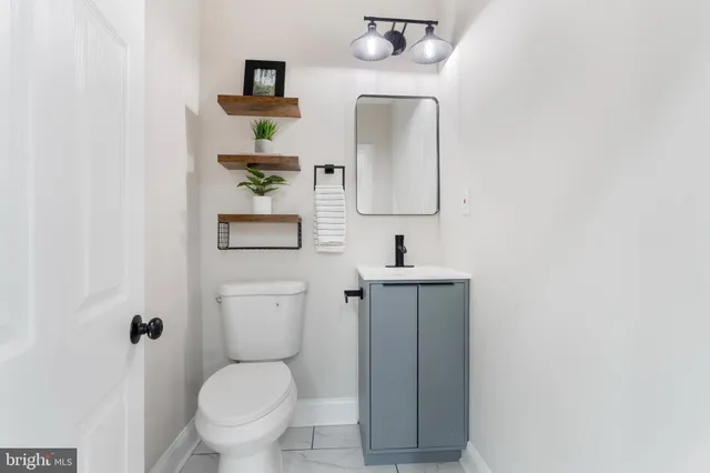 a bathroom with a toilet sink and mirror