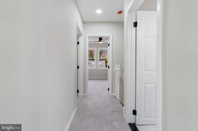 a view of hallway with wooden floor