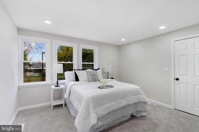 a bedroom with a large bed and a large window