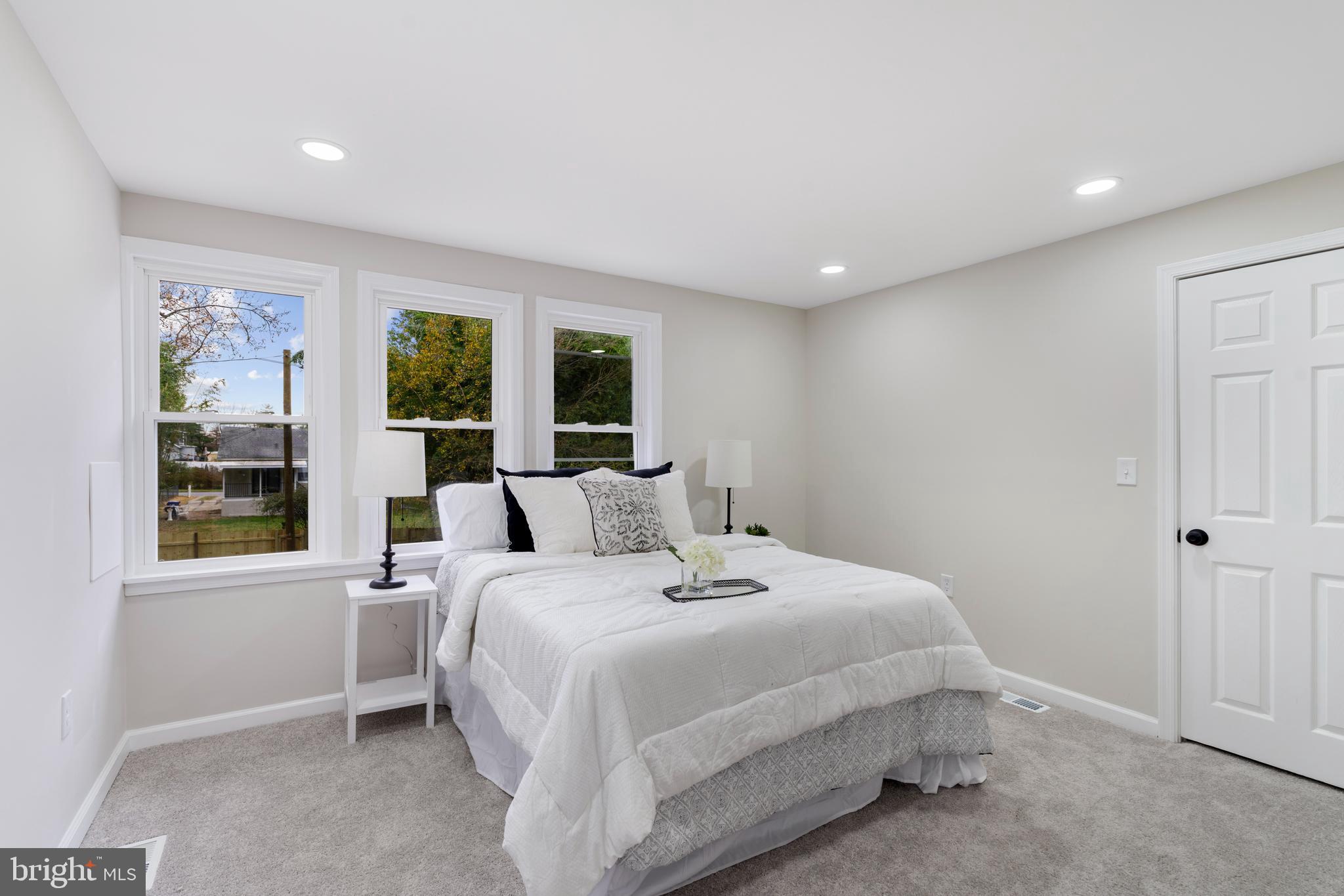 2905 Whitney Avenue Baltimore, MD 21215 - Photo 19 of 36 a bedroom with a large bed and a large window