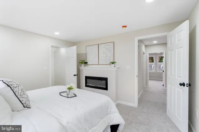 a bedroom with a bed and a fireplace