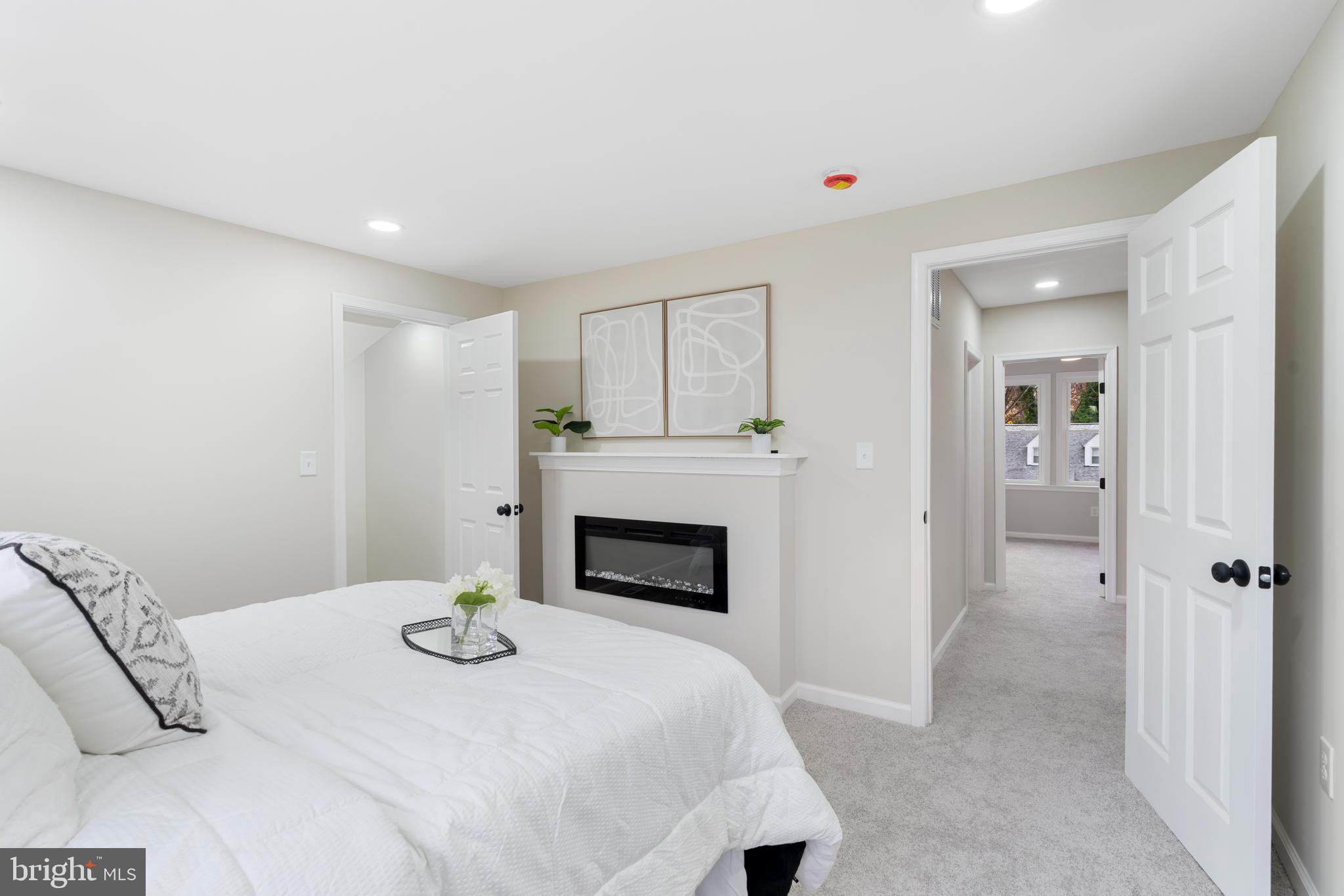 2905 Whitney Avenue Baltimore, MD 21215 - Photo 20 of 36 a bedroom with a bed and a fireplace