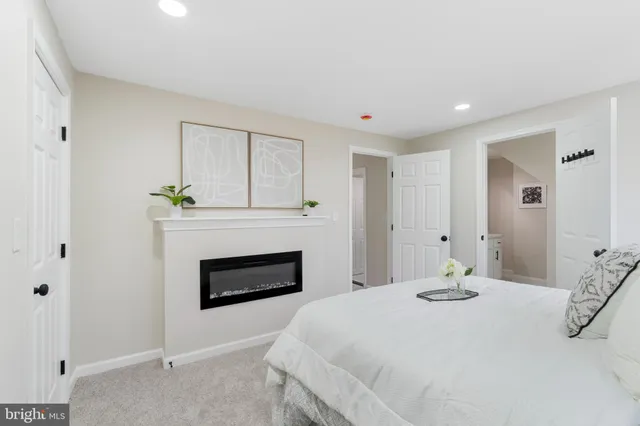 a bedroom with a bed and a fireplace