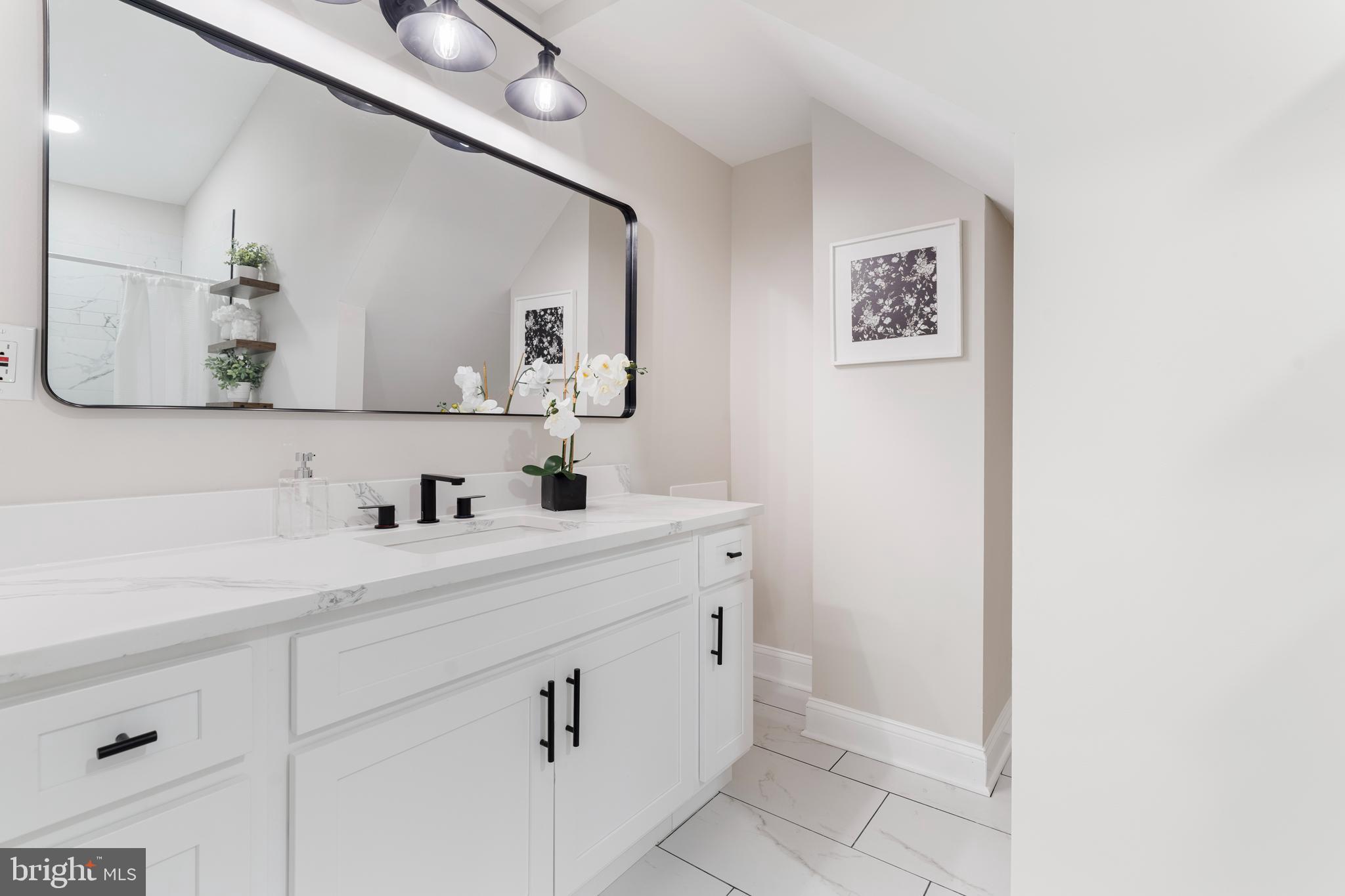 2905 Whitney Avenue Baltimore, MD 21215 - Photo 22 of 36 a bathroom with a sink and a mirror
