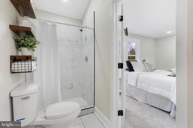 a bathroom with a toilet a sink and shower