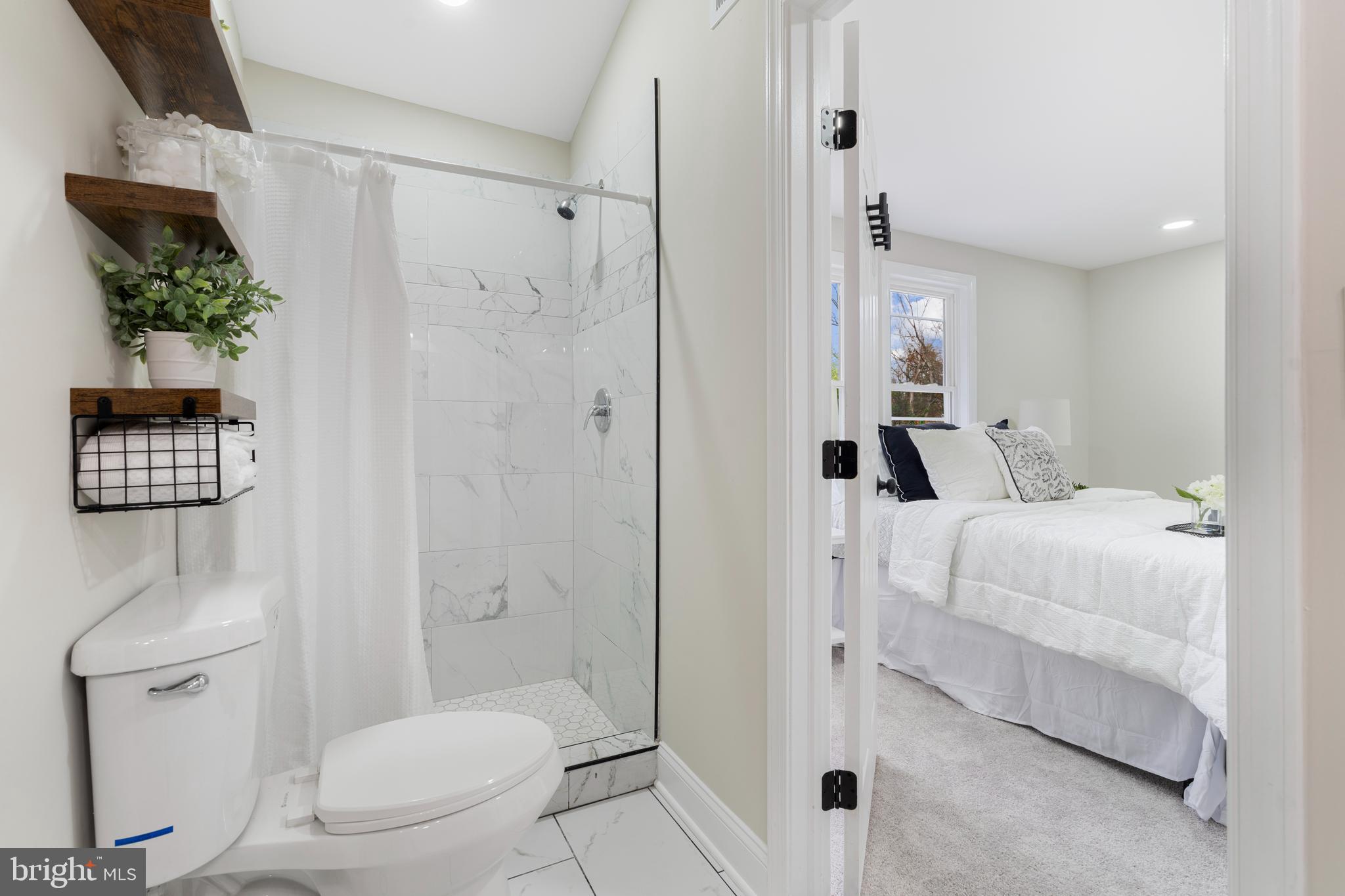 2905 Whitney Avenue Baltimore, MD 21215 - Photo 23 of 36 a bathroom with a toilet a sink and shower