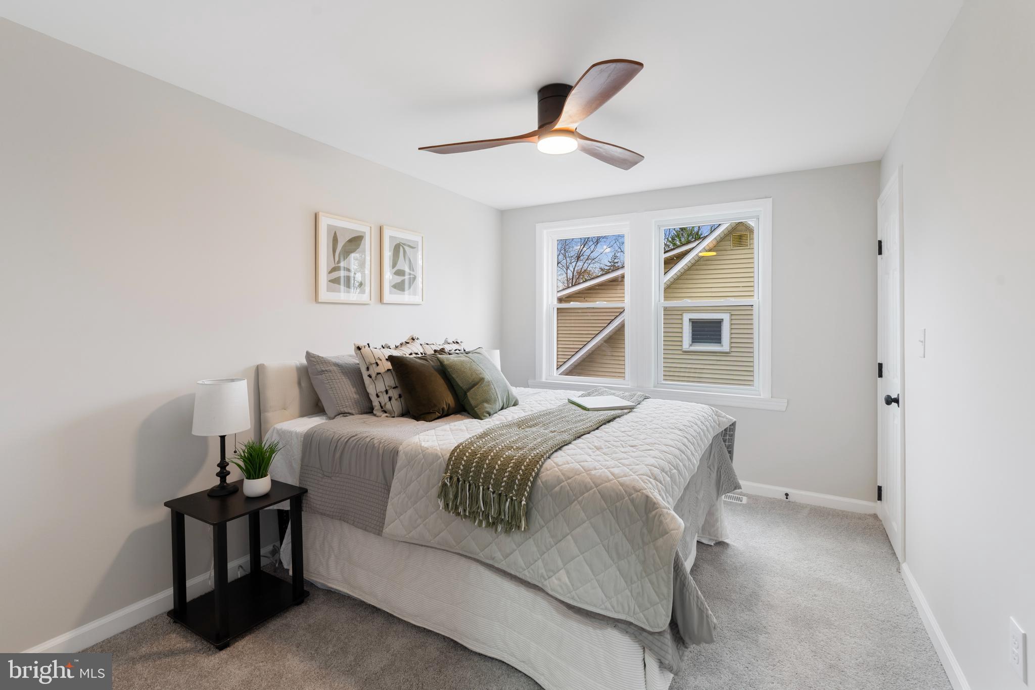 2905 Whitney Avenue Baltimore, MD 21215 - Photo 24 of 36 a spacious bedroom with a bed and painting on the wall