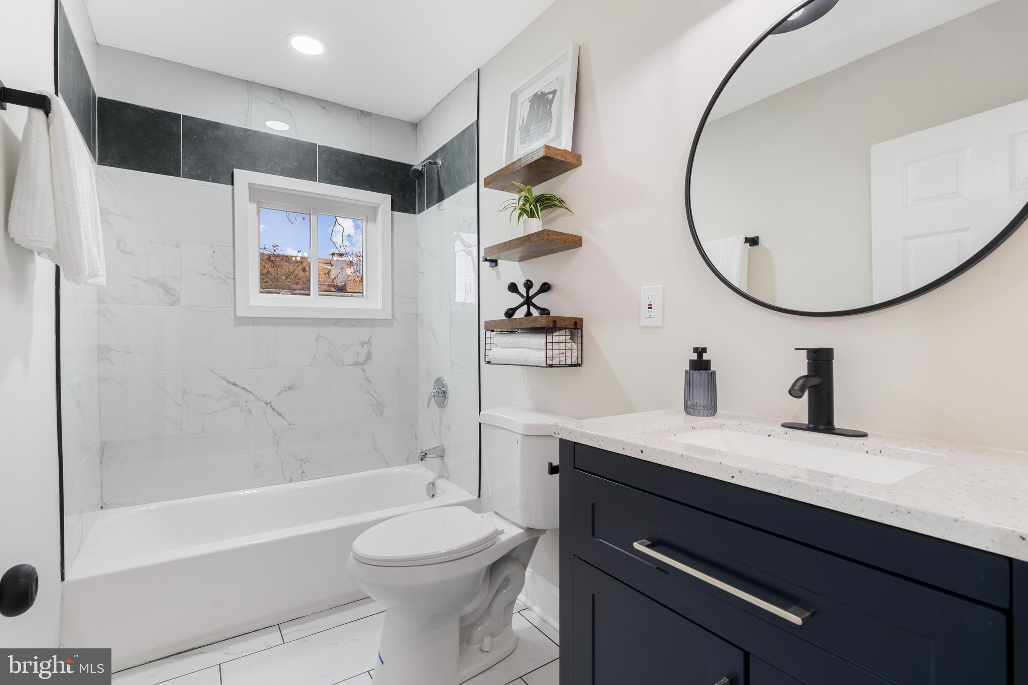 2905 Whitney Avenue Baltimore, MD 21215 - Photo 26 of 36 a bathroom with a sink a toilet and a mirror
