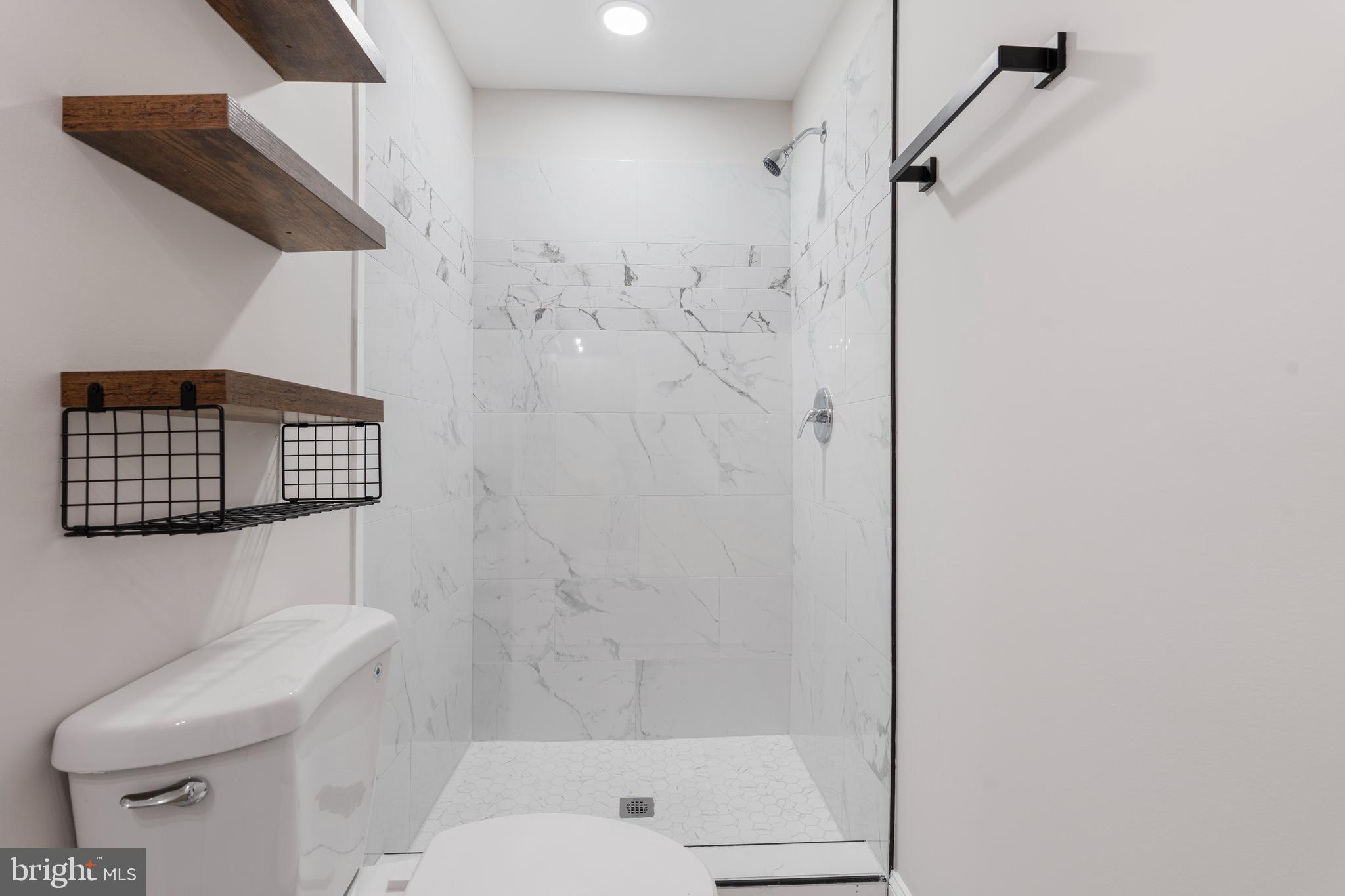 2905 Whitney Avenue Baltimore, MD 21215 - Photo 31 of 36 a bathroom with a shower a toilet and a shower