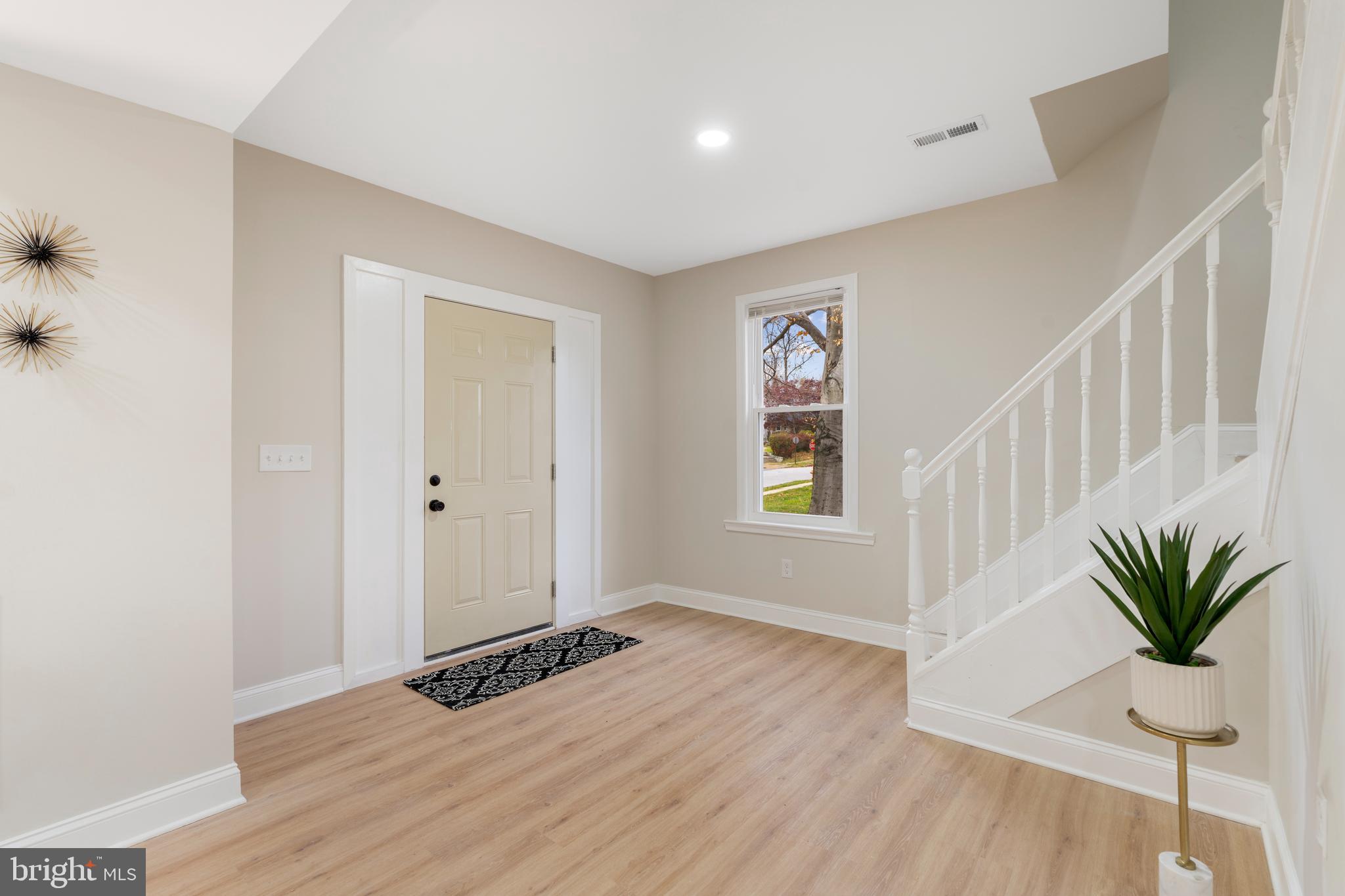 2905 Whitney Avenue Baltimore, MD 21215 - Photo 5 of 36 a view of an empty room with a window and wooden floor