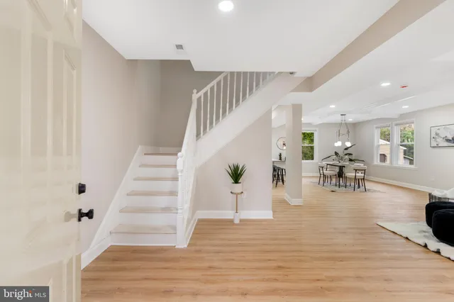 a view of entryway and dining room with wooden floor