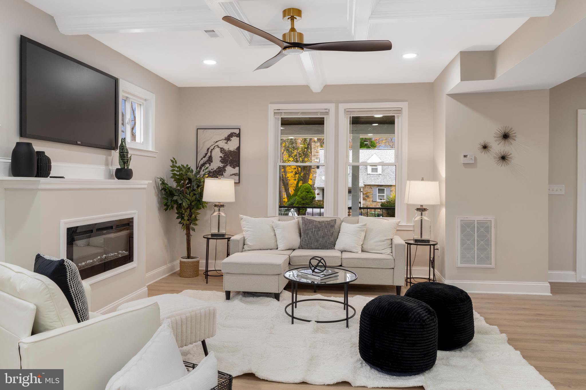2905 Whitney Avenue Baltimore, MD 21215 - Photo 8 of 36 a living room with furniture a flat screen tv and a fireplace