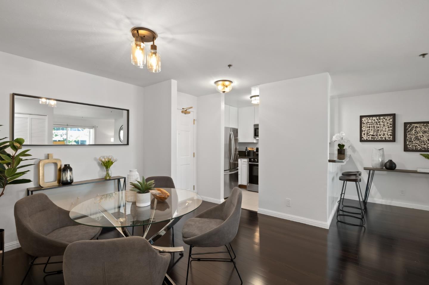 300 Murchison Drive, Unit 108 Millbrae, CA 94030 - Photo 5 of 12 a view of a dining room with furniture and wooden floor