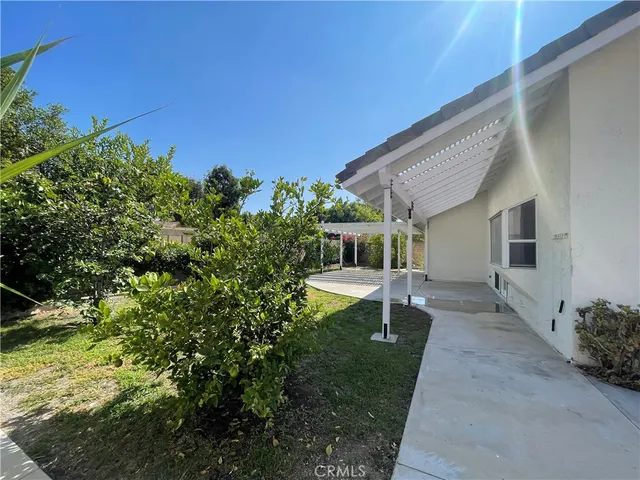 a view of a house with backyard porch and sitting area