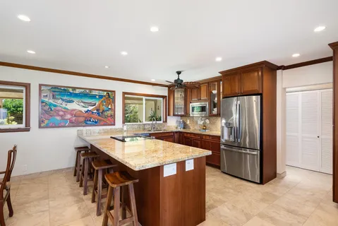 a kitchen with stainless steel appliances granite countertop a stove and a sink