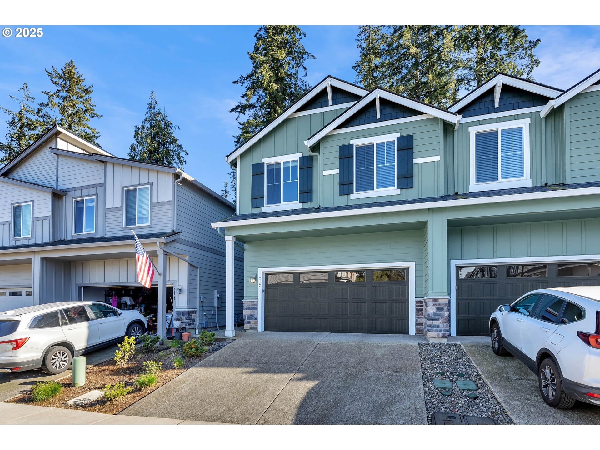 4147 South Canyon View Circle Ridgefield, WA 98642 - Photo 1 of 44 a front view of a house with a yard and garage