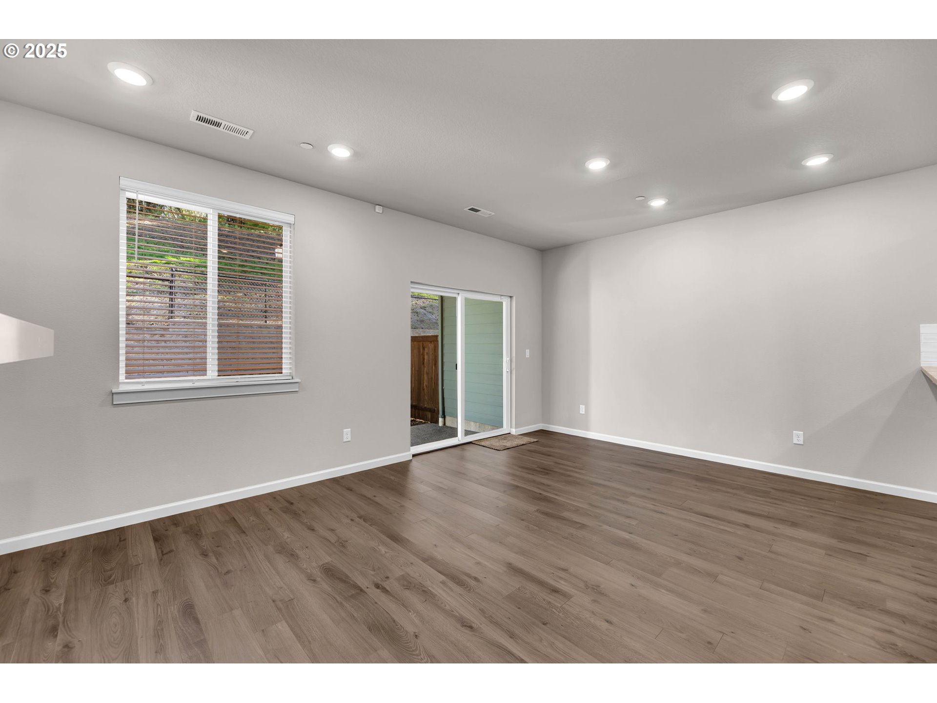 4147 South Canyon View Circle Ridgefield, WA 98642 - Photo 15 of 44 a view of an empty room with wooden floor and windows