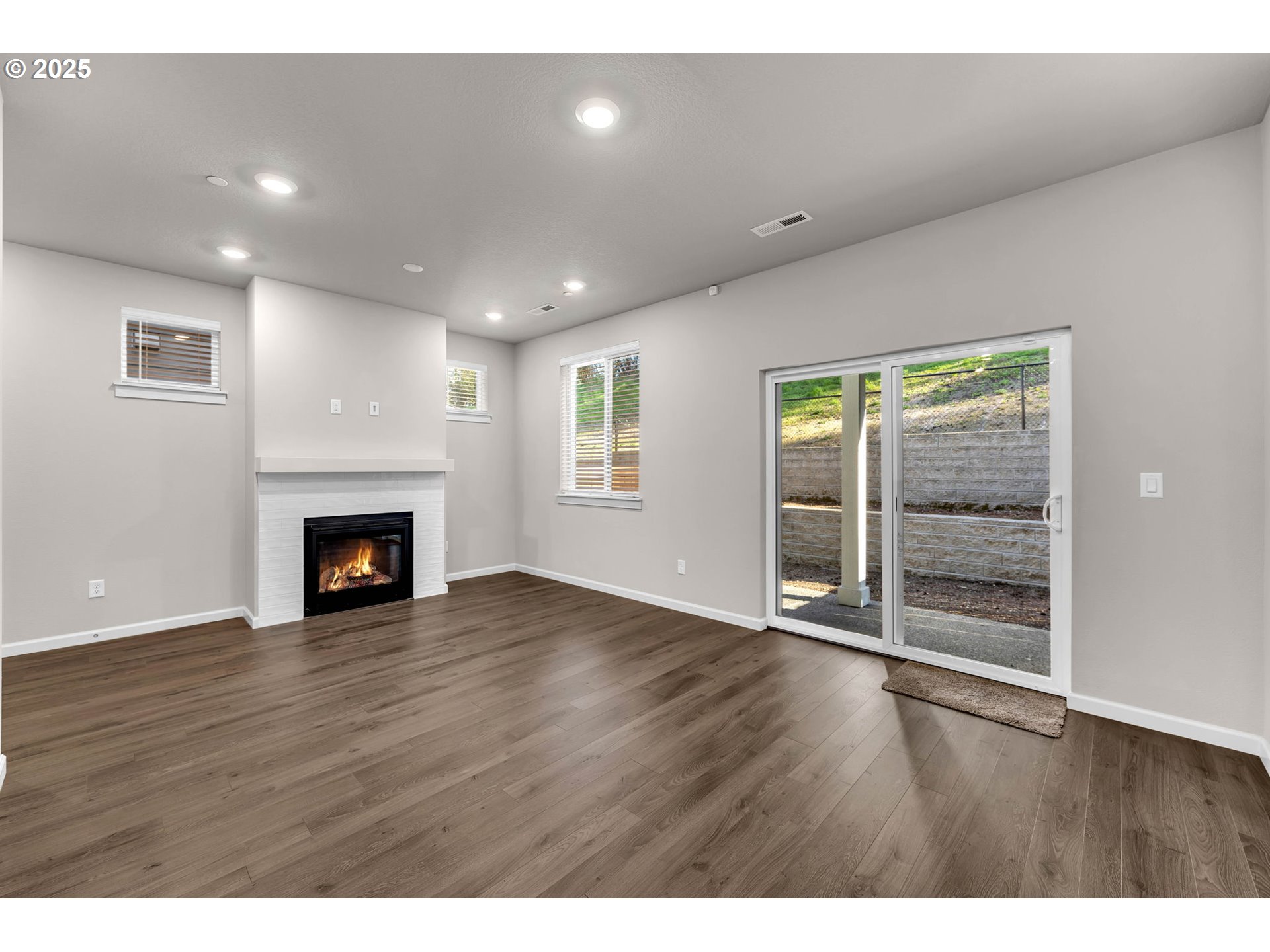 4147 South Canyon View Circle Ridgefield, WA 98642 - Photo 18 of 44 a view of an empty room with wooden floor fireplace and a window