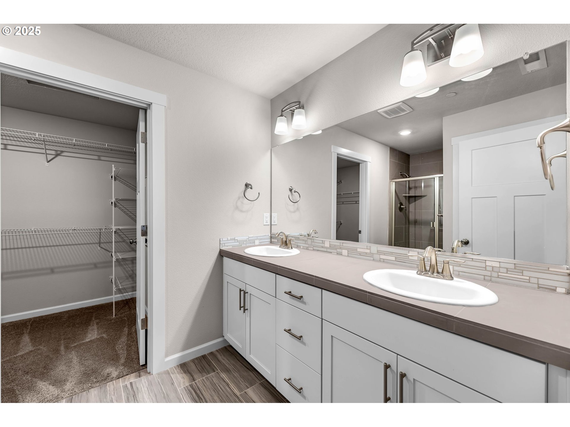 4147 South Canyon View Circle Ridgefield, WA 98642 - Photo 27 of 44 a bathroom with a sink double vanity and a mirror