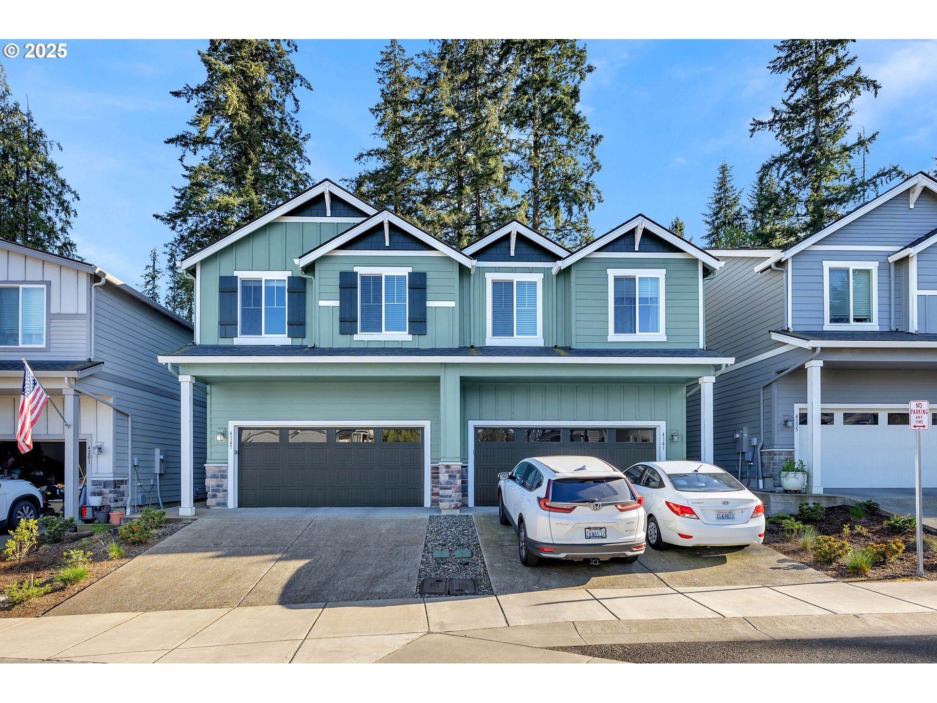 4147 South Canyon View Circle Ridgefield, WA 98642 - Photo 3 of 44 a front view of a house with a garden and garage