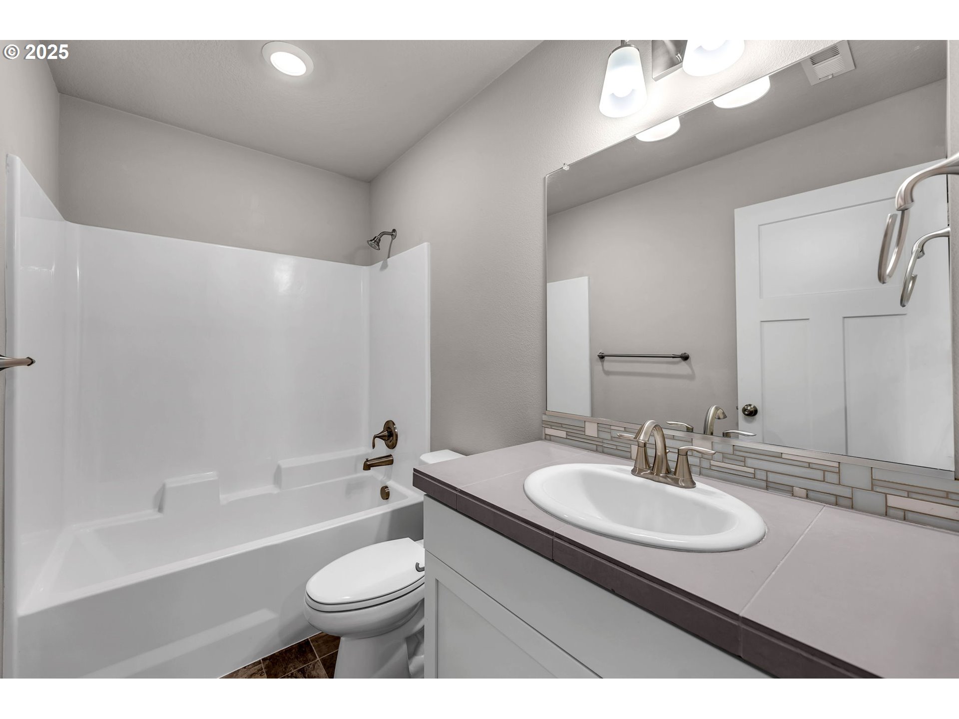 4147 South Canyon View Circle Ridgefield, WA 98642 - Photo 33 of 44 a bathroom with a sink a toilet a mirror a vanity and bathtub