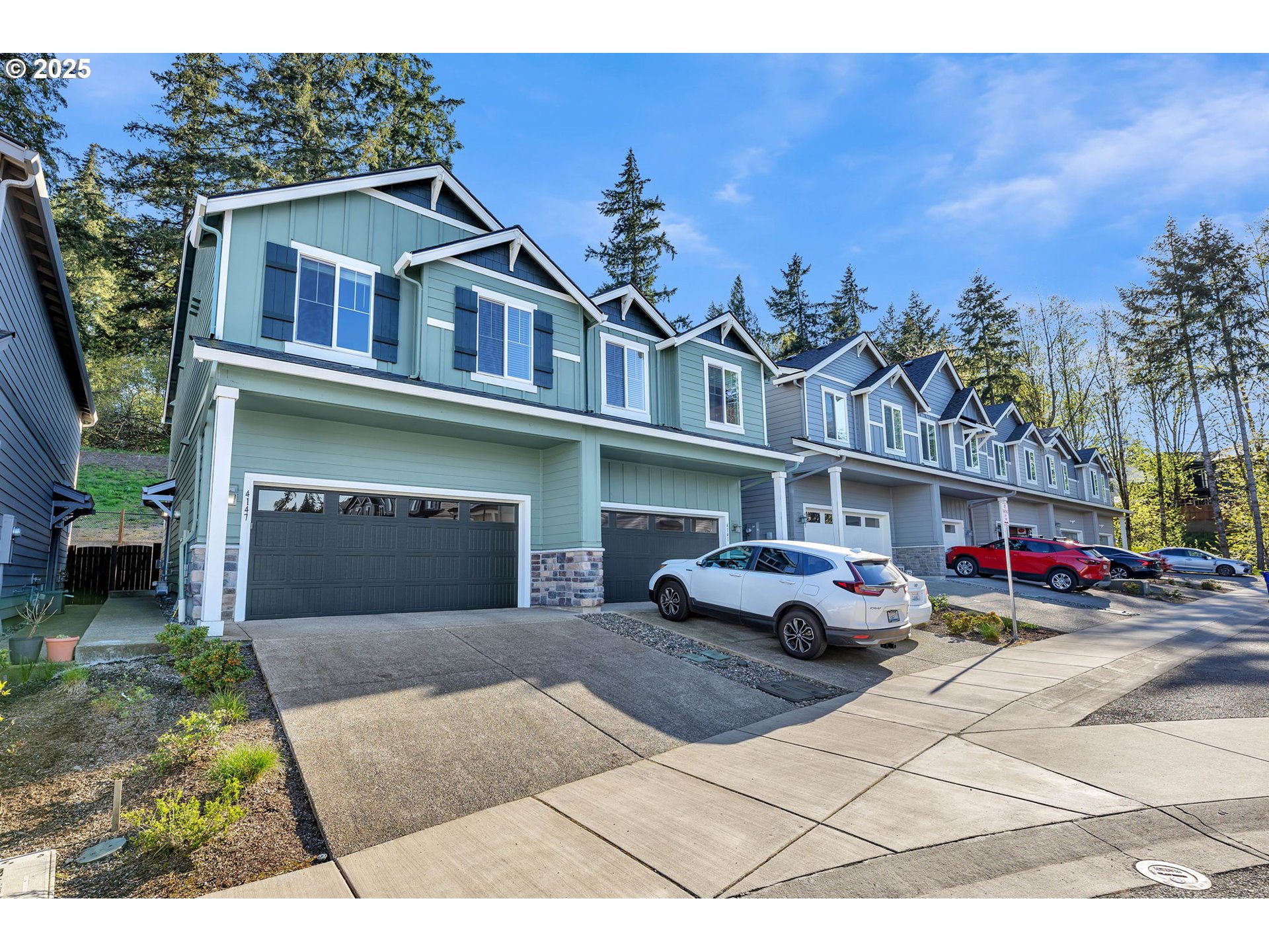 4147 South Canyon View Circle Ridgefield, WA 98642 - Photo 4 of 44 a front view of a house with a yard and garage