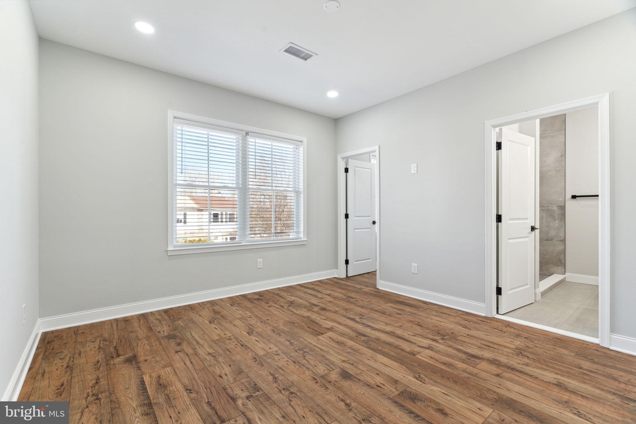 48 Evergreen Lane Phoenixville, PA 19460 - Photo 20 of 42 a view of an empty room with wooden floor and a window
