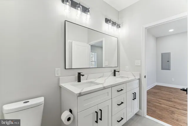 a bathroom with a toilet sink and mirror