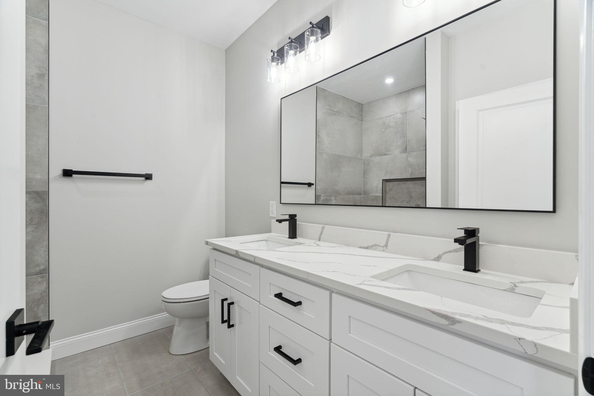 48 Evergreen Lane Phoenixville, PA 19460 - Photo 23 of 42 a bathroom with a toilet sink and mirror