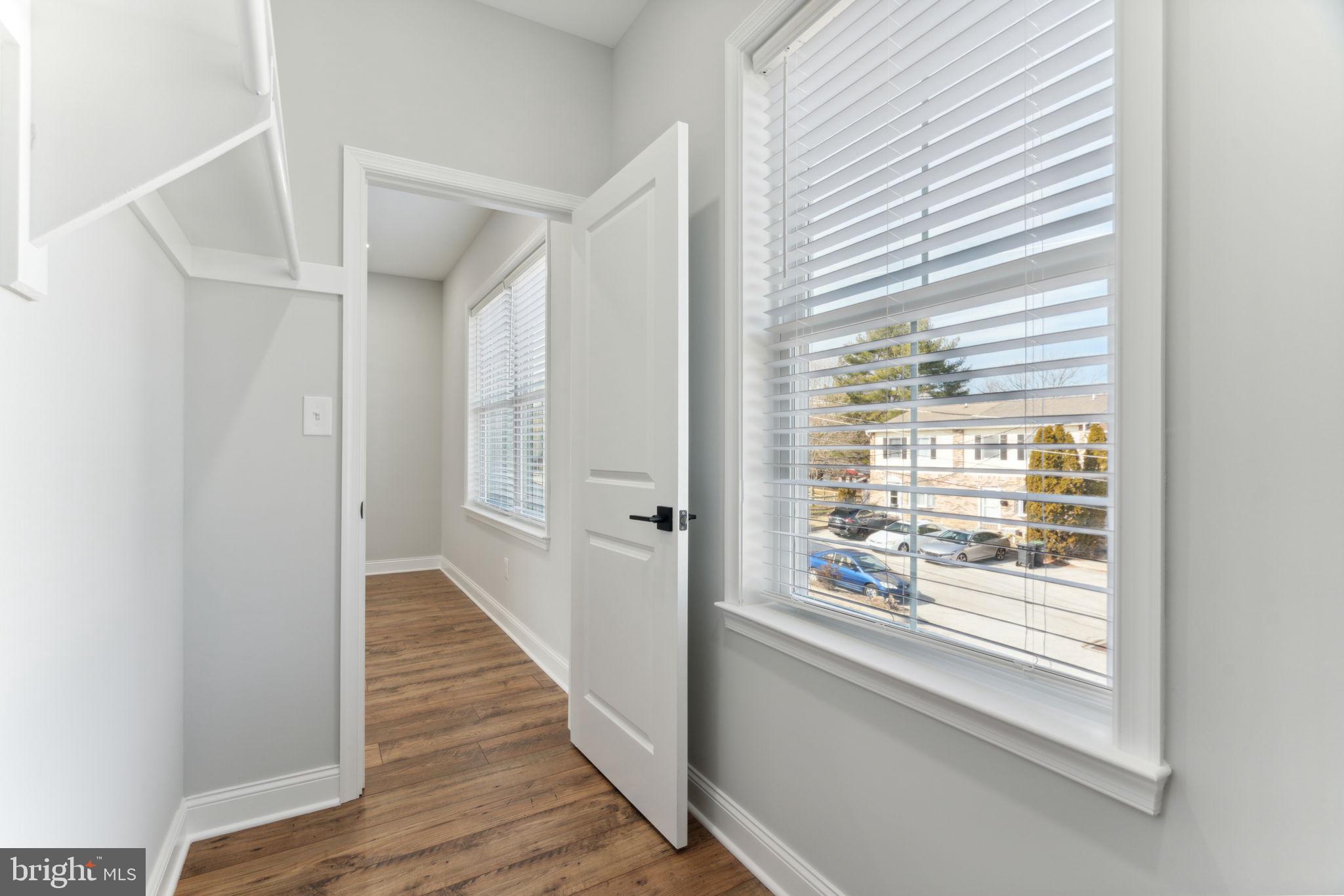 48 Evergreen Lane Phoenixville, PA 19460 - Photo 25 of 42 a view of a hallway with wooden floor and windows