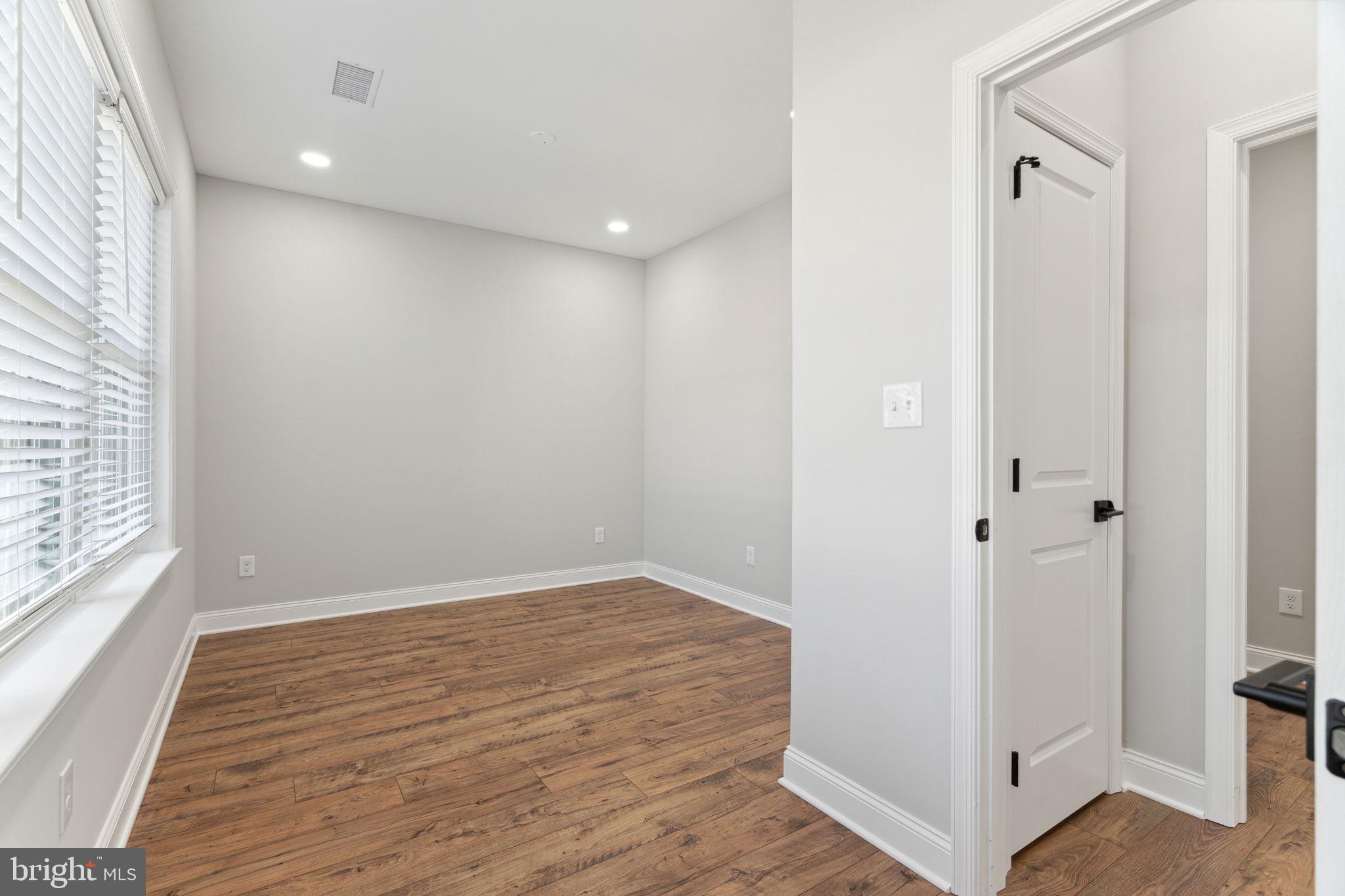 48 Evergreen Lane Phoenixville, PA 19460 - Photo 30 of 42 a view of an empty room with wooden floor and a window
