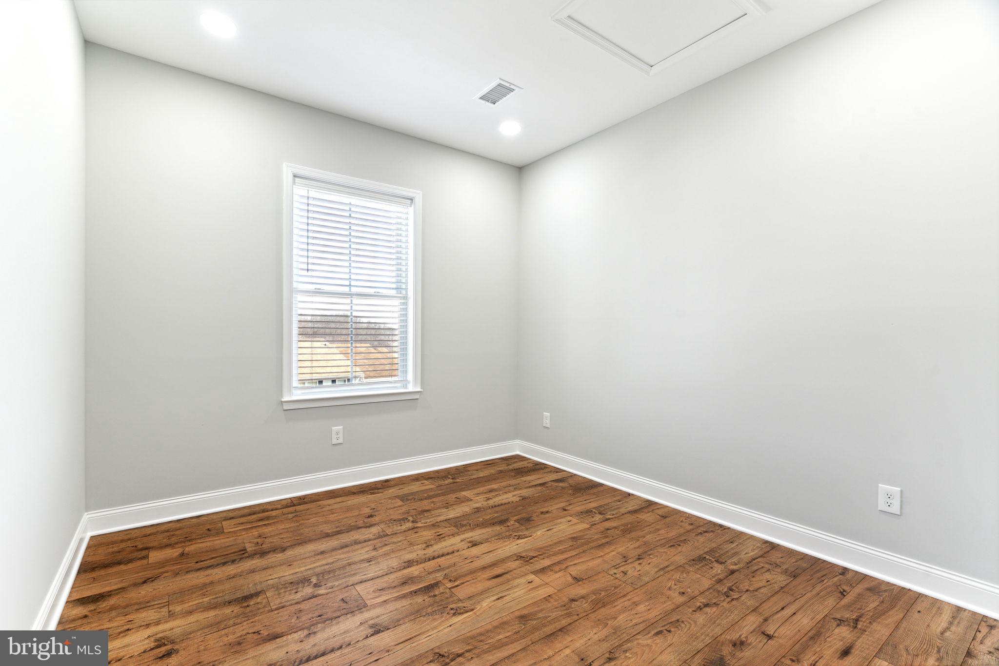 48 Evergreen Lane Phoenixville, PA 19460 - Photo 31 of 42 an empty room with wooden floor and windows