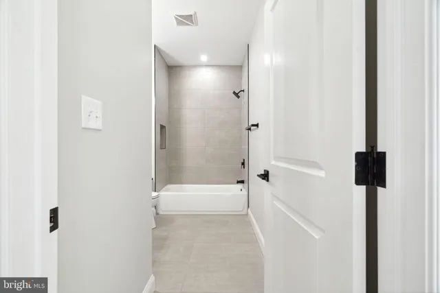 a bathroom with a bathtub and shower